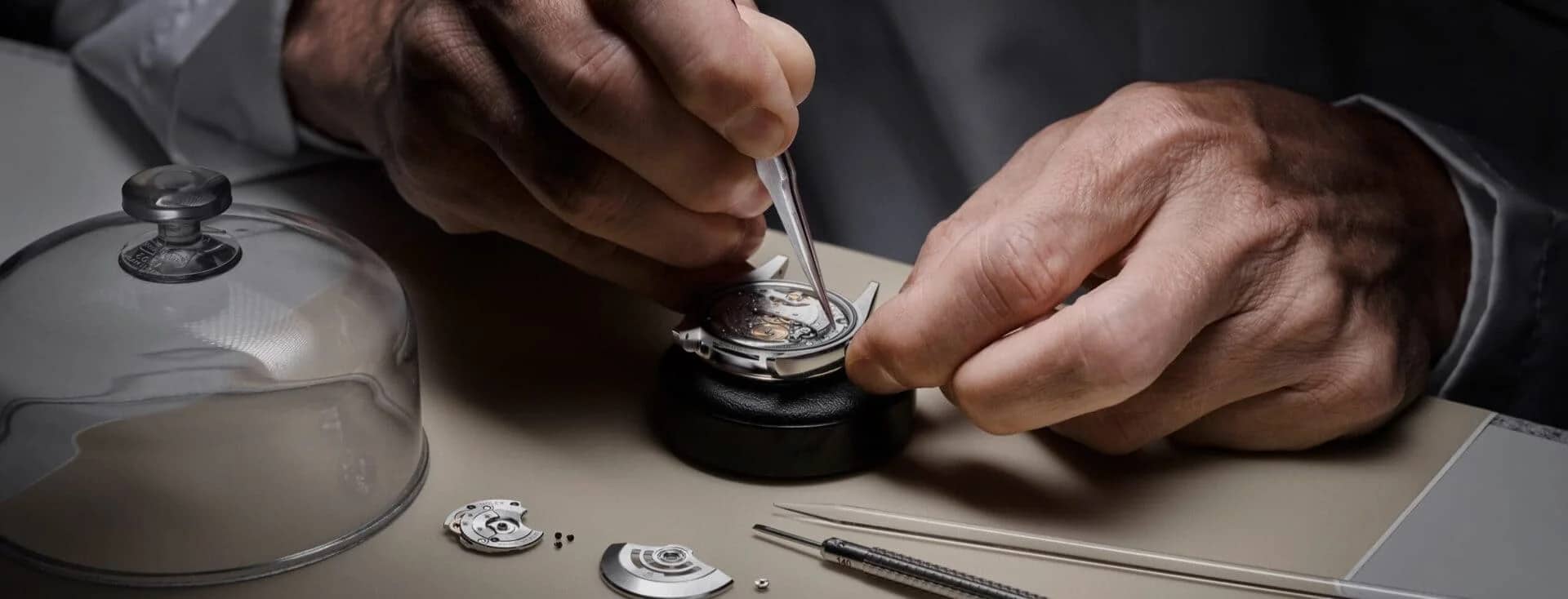A Rolex watchmaker meticulously servicing a movement. - Chang Ein Hong