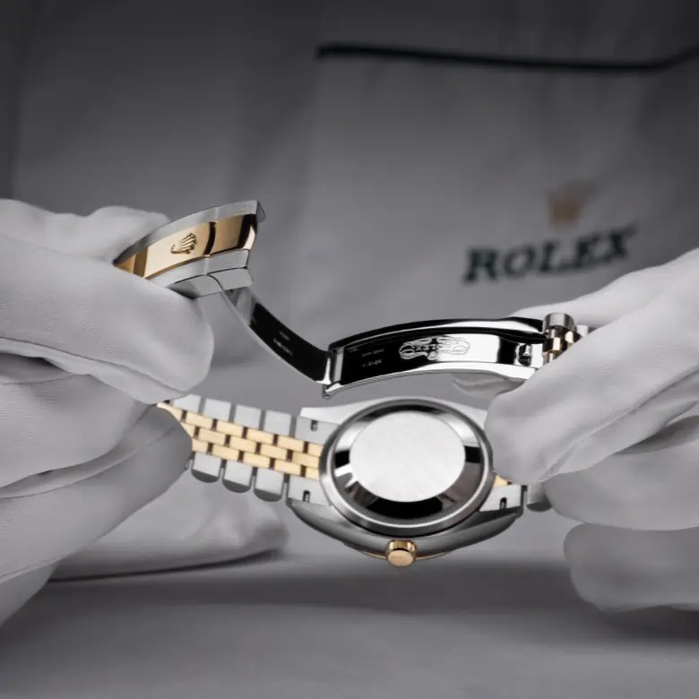 Gloved hands inspecting a Rolex case and bracelet during servicing. - Chang Ein Hong