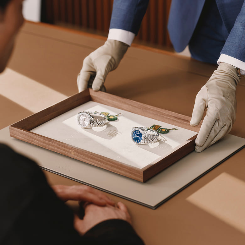 Rolex specialist presenting two watches to a client - Chang Ein Hong
