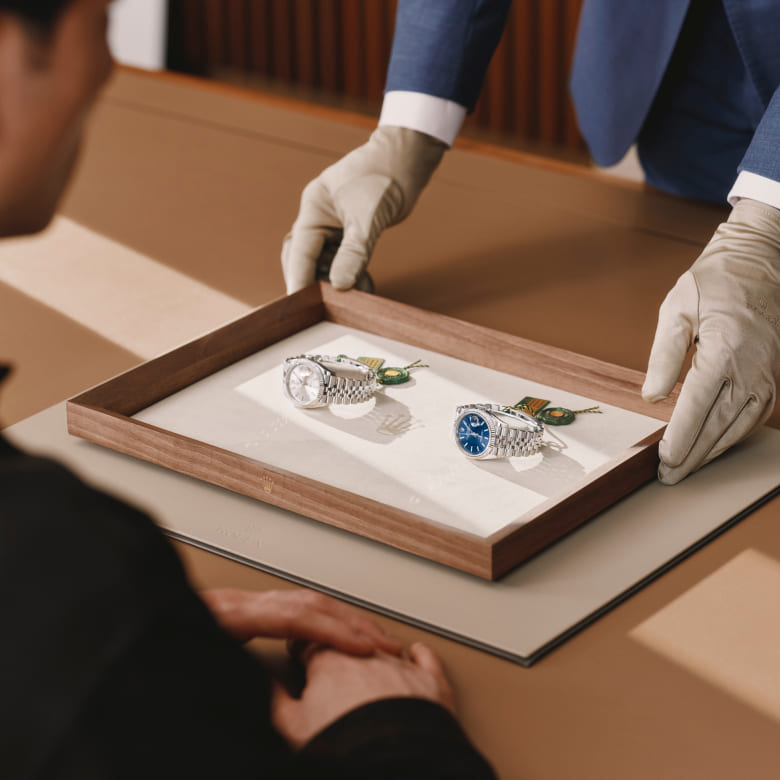 Rolex specialist presenting two watches to a client - Chang Ein Hong