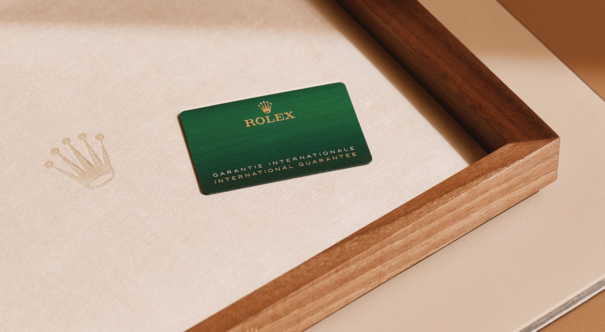 Rolex international guarantee card displayed on a wooden presentation tray - Chang Ein Hong
