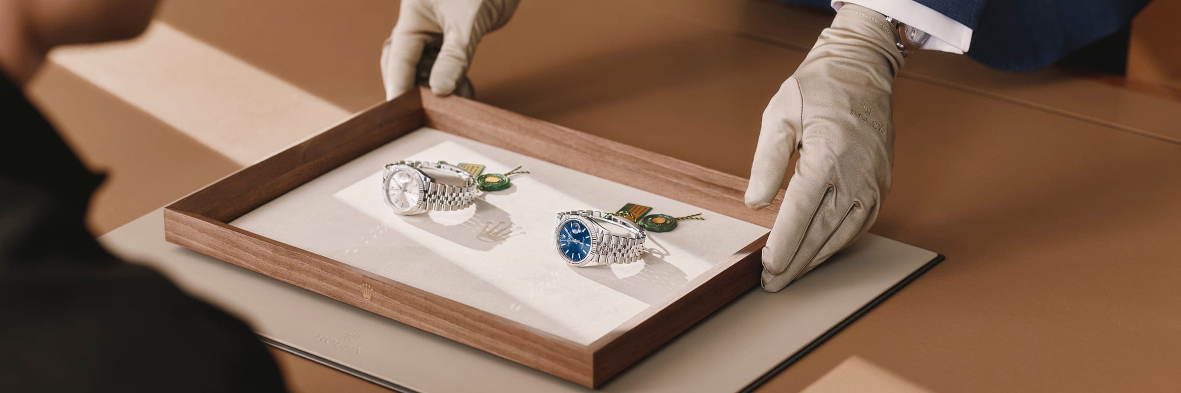 Rolex specialist presenting two watches to a client - Chang Ein Hong
