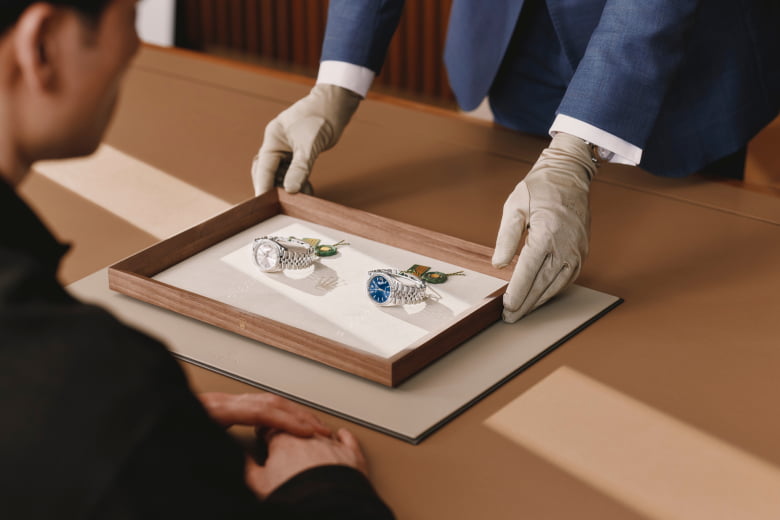 Rolex specialist presenting two watches to a client - Chang Ein Hong