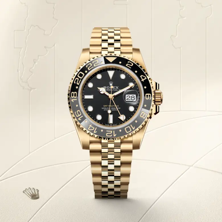 The The Rolex GMT-Master II in yellow gold shown against a muted, elegant background. - Chang Ein Hong