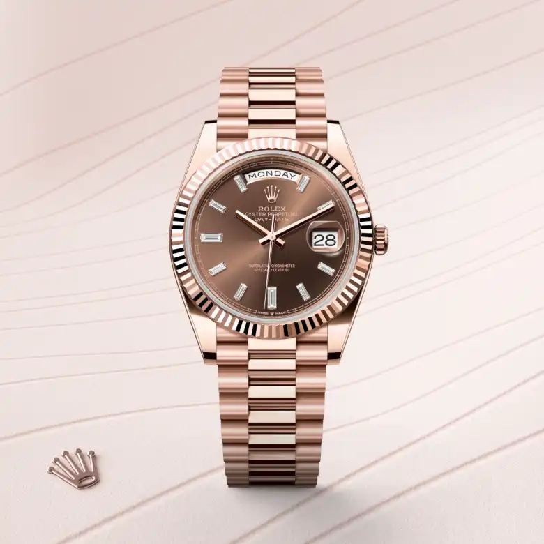 The The Rolex Day-Date 40 in Everose gold shown against a muted, elegant background. - Chang Ein Hong