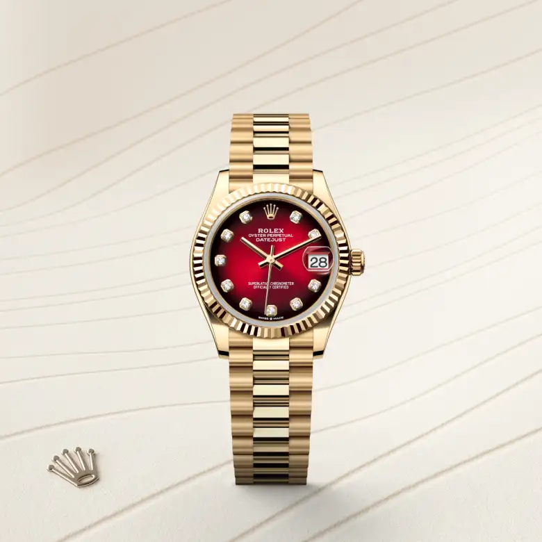 The The Rolex Datejust 31 in yellow gold shown against a muted, elegant background. - Chang Ein Hong