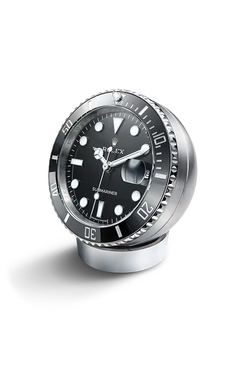 The Submariner desk clock in stainless steel, with a Cerachrom bezel insert and Chromalight display, incorporates a secular calendar. - Chang Ein Hong